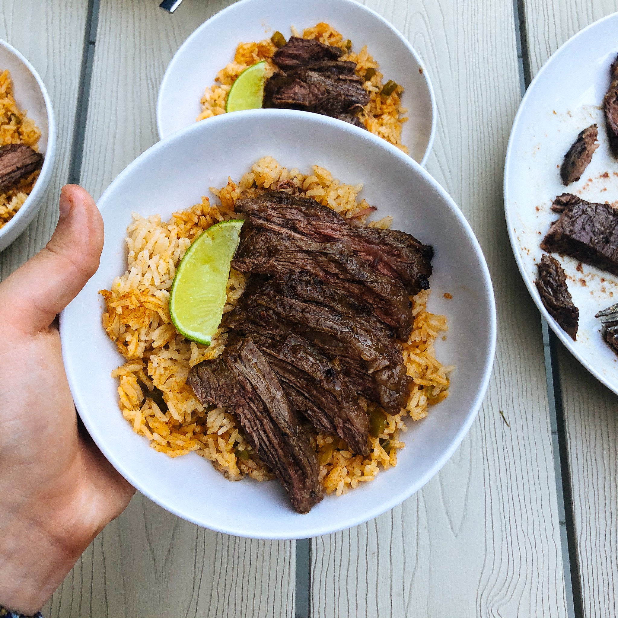 finished plate of carne asada and spanish confetti rice