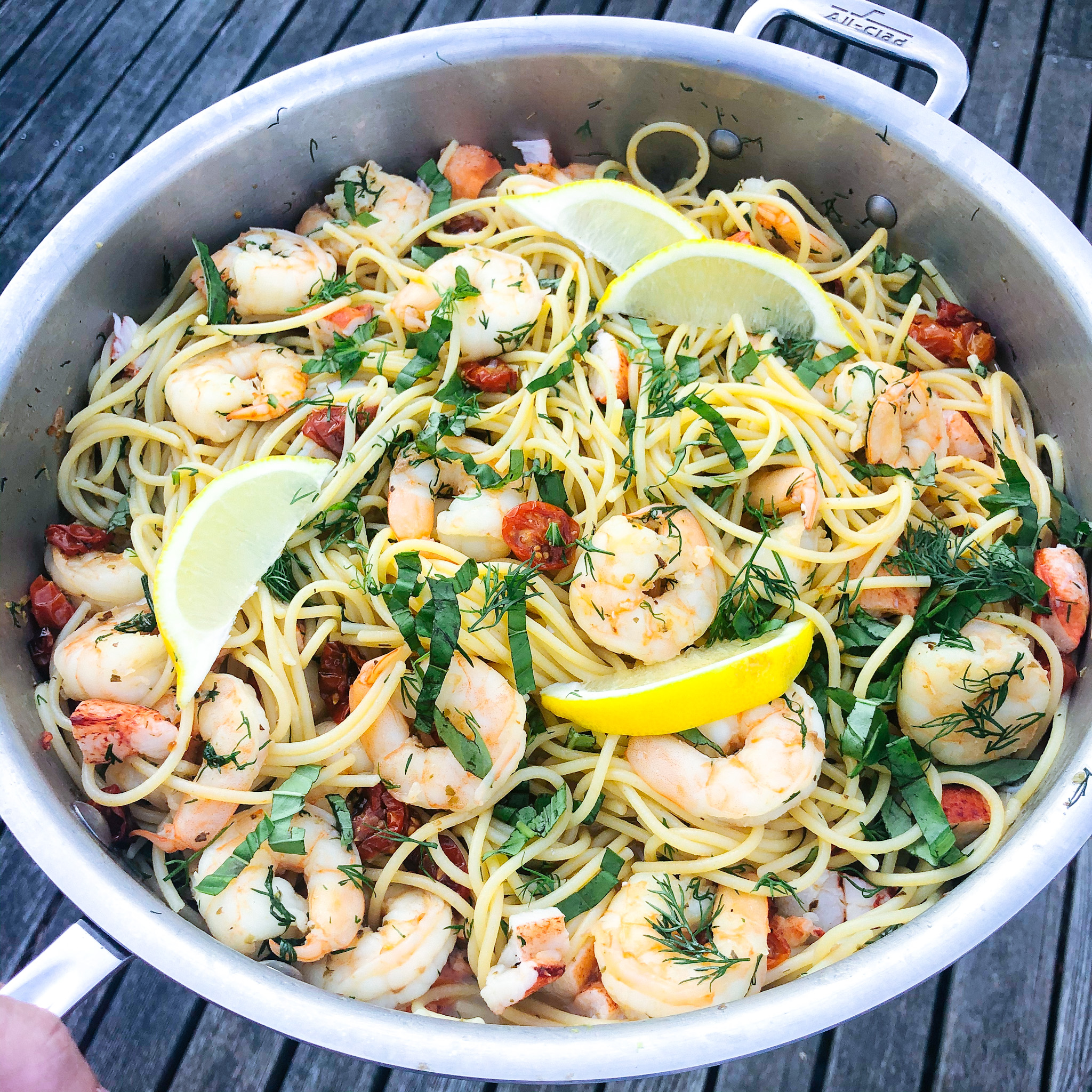 the finished seafood pasta dish with lemon and dill