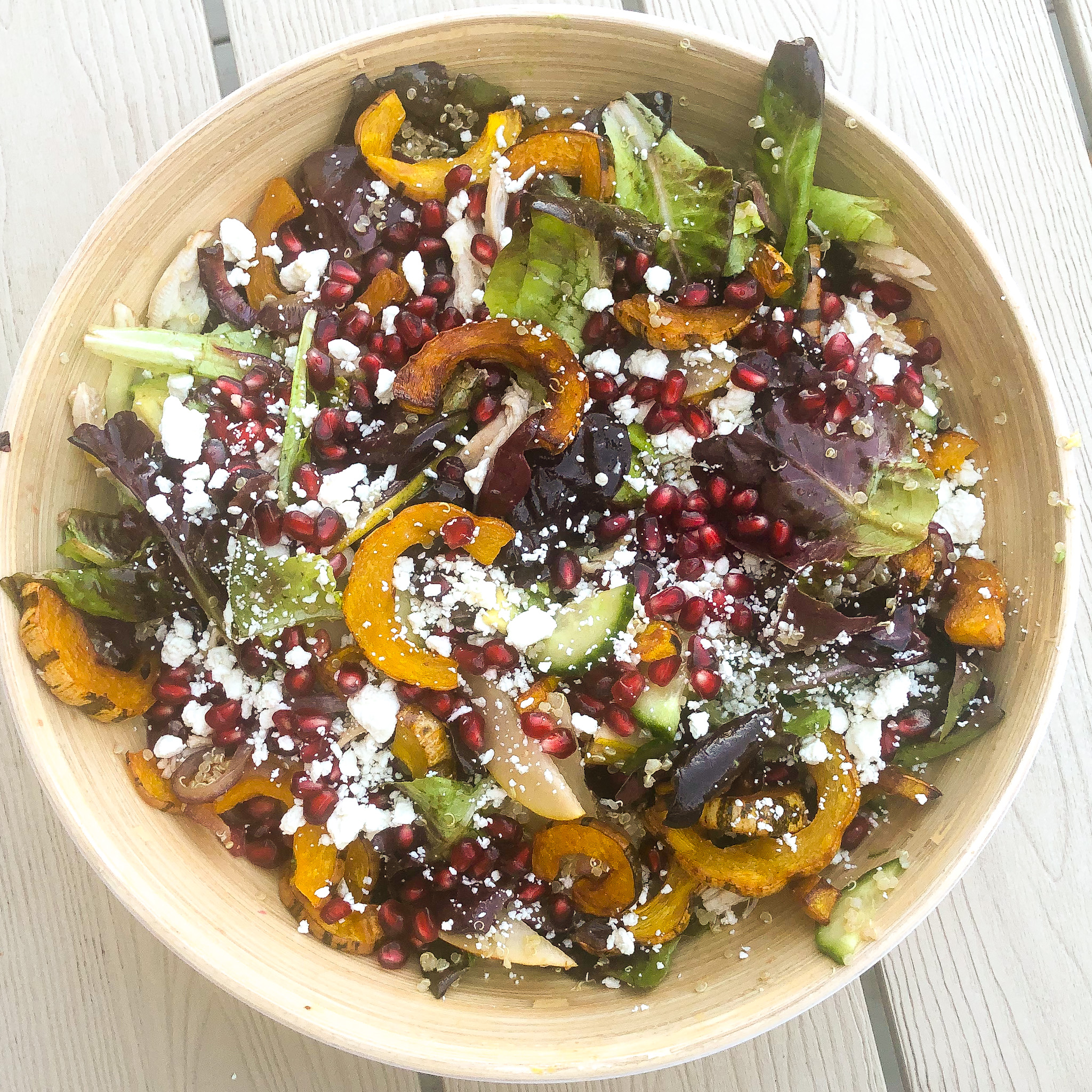 the finished fall squash salad, topped with pomegranate and goat cheese